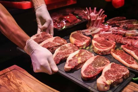 vista-lateral-o-chef-faz-carne-marmorizada-crua-para-bifes-em-um-carrinho.jpg